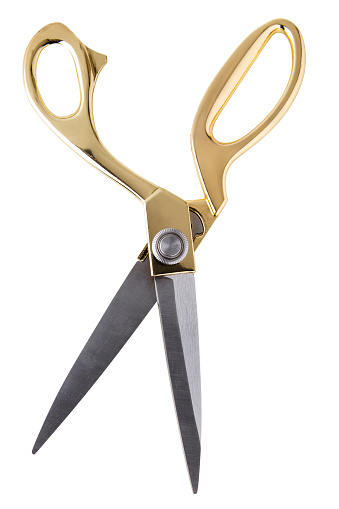 Pair of tailor scissors with metal golden handle isolated on white background.