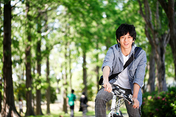 Oriental Male Students a male student who is attending school bicycle cycling school child stock pictures, royalty-free photos & images