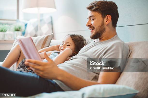 Father And Daughter Enjoying At Home Stock Photo - Download Image Now - 2015, 25-29 Years, 4-5 Years