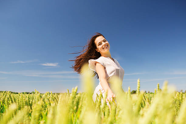 istock smiling young woman on cereal field 478522248