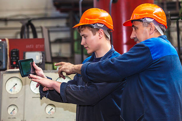 homens a trabalhar na antiga fábrica para a instalação - young male fotos imagens e fotografias de stock