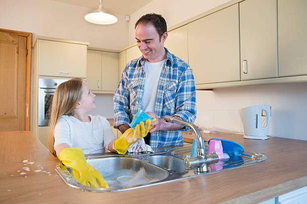 istock Father and Daughter Washing Dishes 478525624