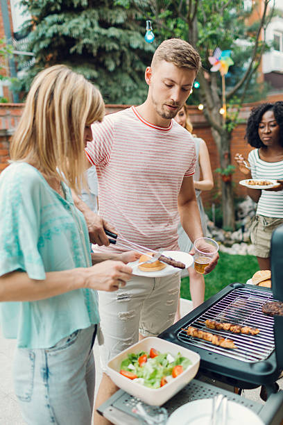 istock Young People Eating At Barbecue Party. 478525740