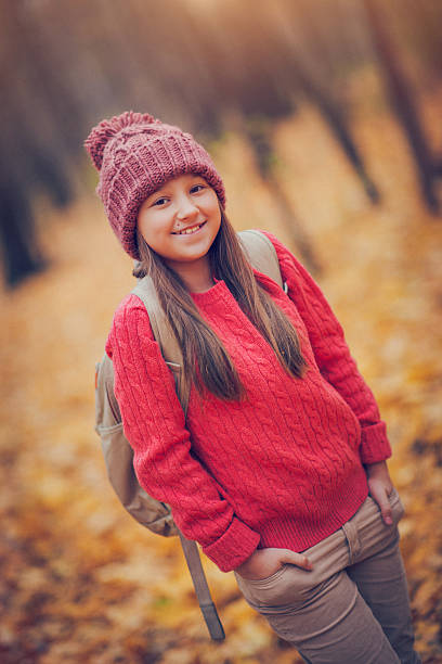 istock Schoolgirl  in autumn 478528476