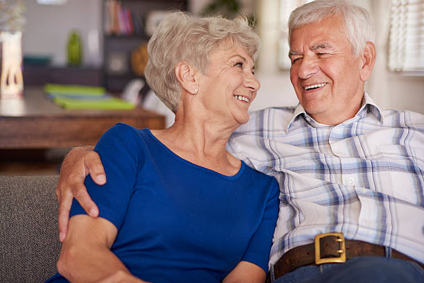istock Happy senior couple on te sofa 478529328