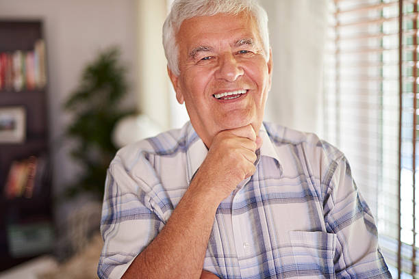 istock Cheerful senior man in his living room 478529672