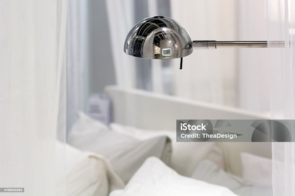 Metal desk lamp Metal desk lamp over white pillows 2015 Stock Photo