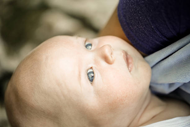 istock Curious baby with blue eyes looking at trees and skies 478540870