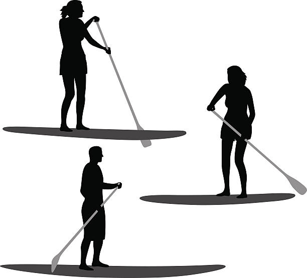 Paddle Boarding Silhouettes Vector silhouettes of a man and woman paddle boarding. paddleboard stock illustrations