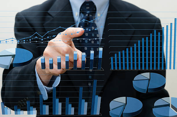 istock Businessman pointing business charts (XXXLarge) 478545734