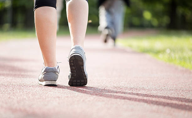 istock Runner athlete feet running on road 478545746
