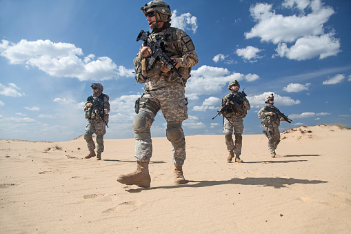 United States paratroopers airborne infantrymen in action in the desert