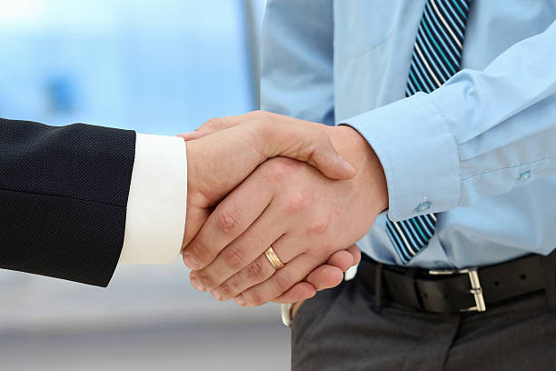 istock Image of a firm handshake  between two colleagues in office 478547000
