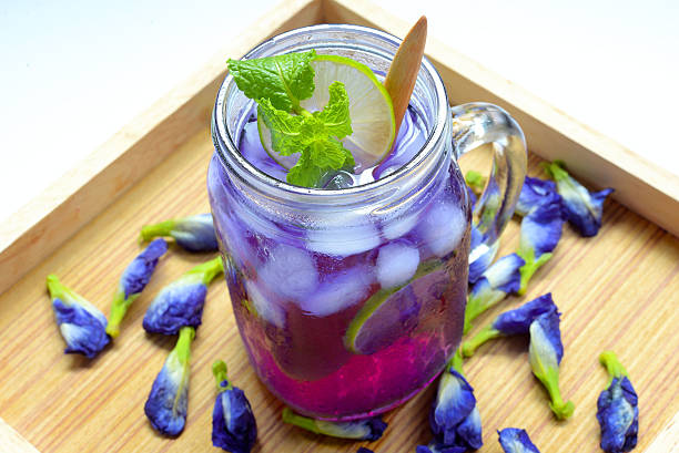 Glass of butterfly pea flower juice - herb drink stock photo