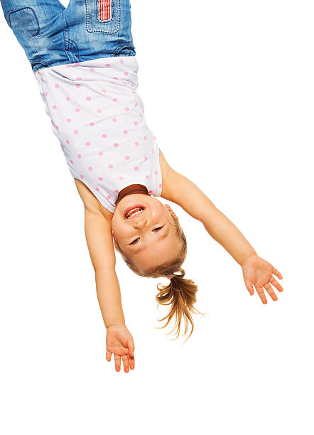 istock Little girl hanging upside down 478549543