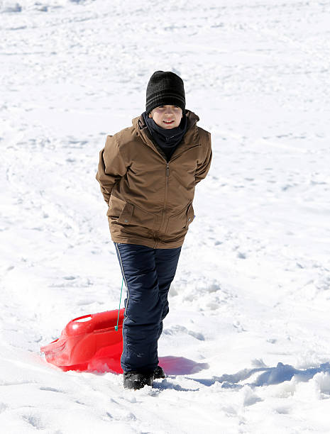 istock boy plays with bob on the snow in the mountains 478551618