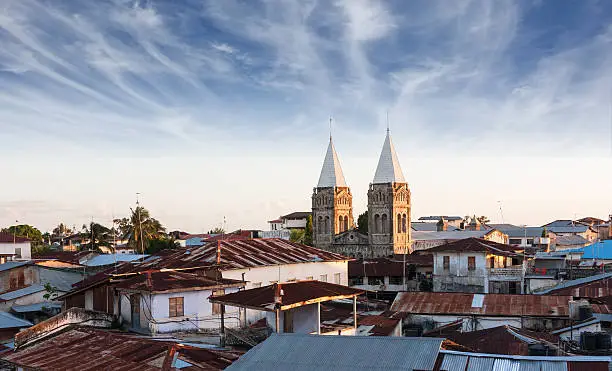 stonetown zanzibar roof-top view over city showing rusted zince roof's and church spires