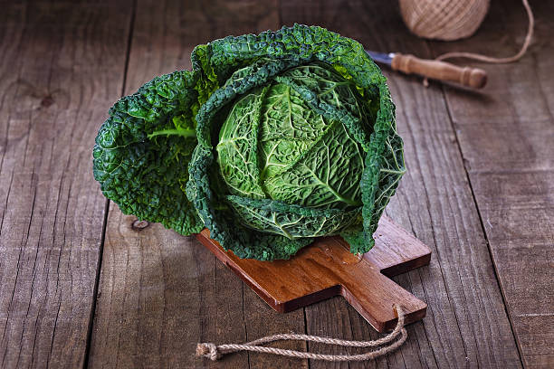 istock Savoy cabbage over wooden background 478552176