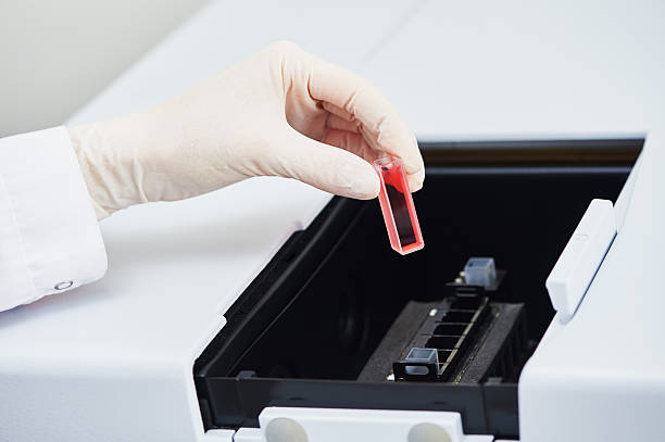 istock hand in glove with flask test at pharmacy lab 478554072