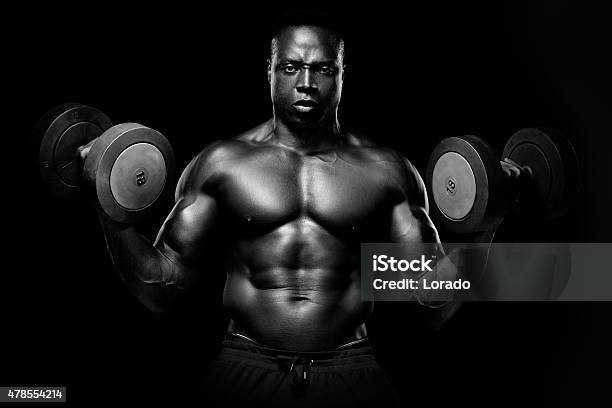 Muscular Black Male Lifting Weights Stock Photo - Download Image Now - 2015, Activity, Adult