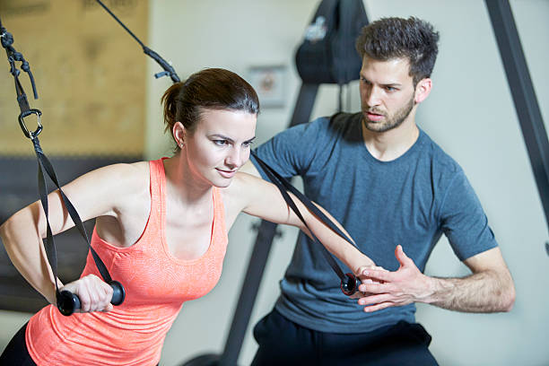 istock Couple in fitness studio at suspension training 478554270