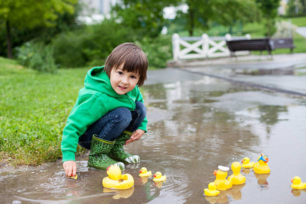 istock Little boy, jumping in muddy puddles in the park 478554484