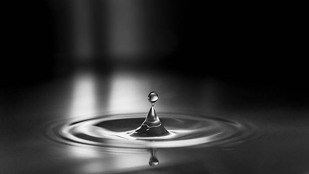 istock Impact and rebound droplet formed on smooth water surface 478555846