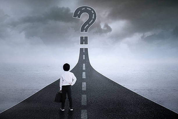 istock Little businessman with question mark at street 478559328