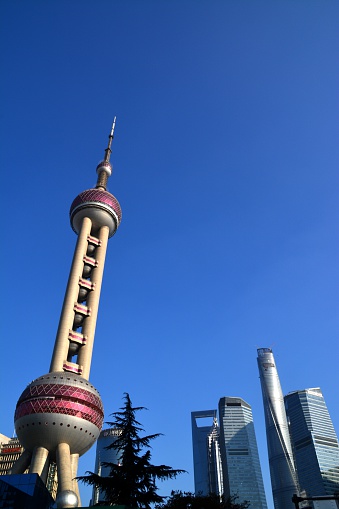 The Oriental Pearl Radio & TV Tower in Pudong, Shanghai. Its antenna spire have an eight of 468 mt. It's one of Shanghai's landmarks.