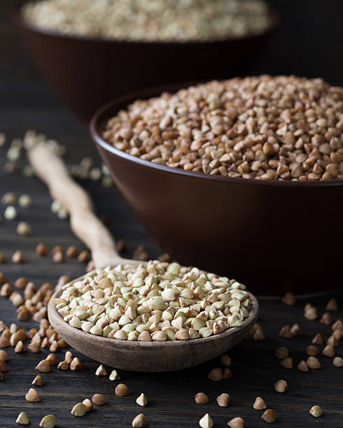 istock Green and brown buckwheat in ceramic bowls 478561136