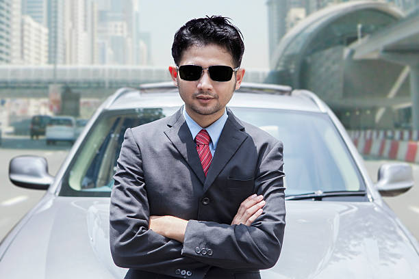istock Successful person standing in front of car 478561434