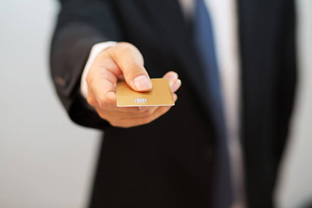 istock man's hand holding a credit card 478561510