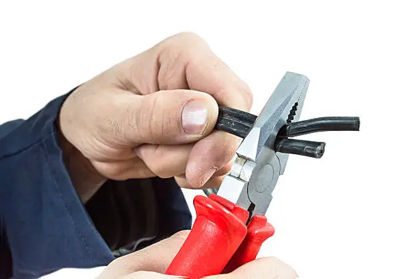 Photo of Hand with universal pliers.