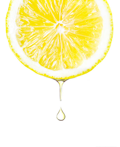 istock Sliced lemon with juice dropping. Isolated on white 478561918