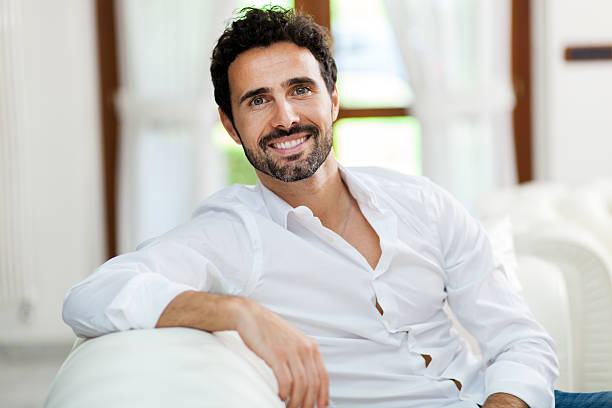 istock Smiling young man relaxing and dreaming on sofa at home 478562278