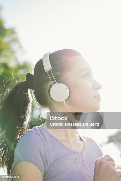 Beautiful Woman Running And Listening To Her Favorite Music Stock Photo - Download Image Now