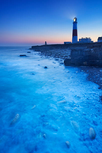 The Portland Bill Lighthouse on the Isle of Portland in Dorset, England at night.