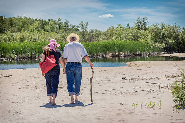 istock middle aged couple strolling hand in hand on the beach 478566828