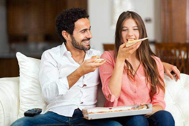 istock Couple with pizza and TV remote 478567224