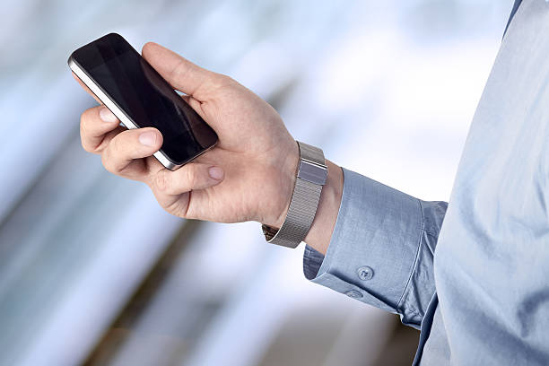 istock Businessman holding  and using the  mobile  smartphone 478568272