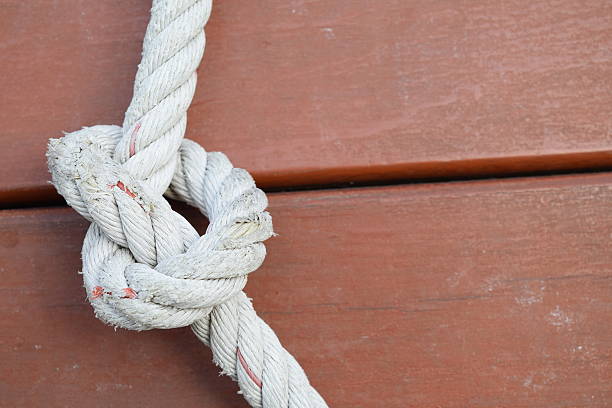 istock Rope knot on wooden floor background 478570848