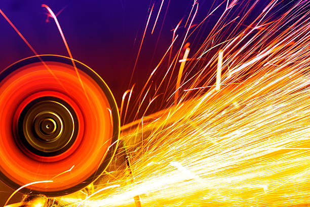 Sparks from circular saw. Metal sawing close up.