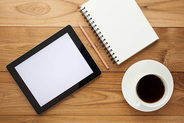 istock Cup of hot coffee and diary on wood table background 478571984