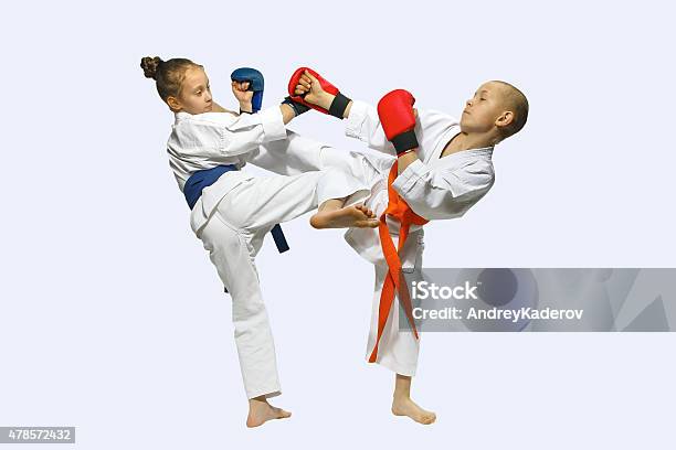 Sportsmen With Overlays On Hands Are Training Hitting Mawashi Geri Stock Photo - Download Image Now