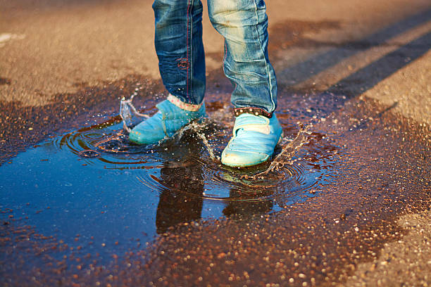 istock The child jumps in a puddle 478575992