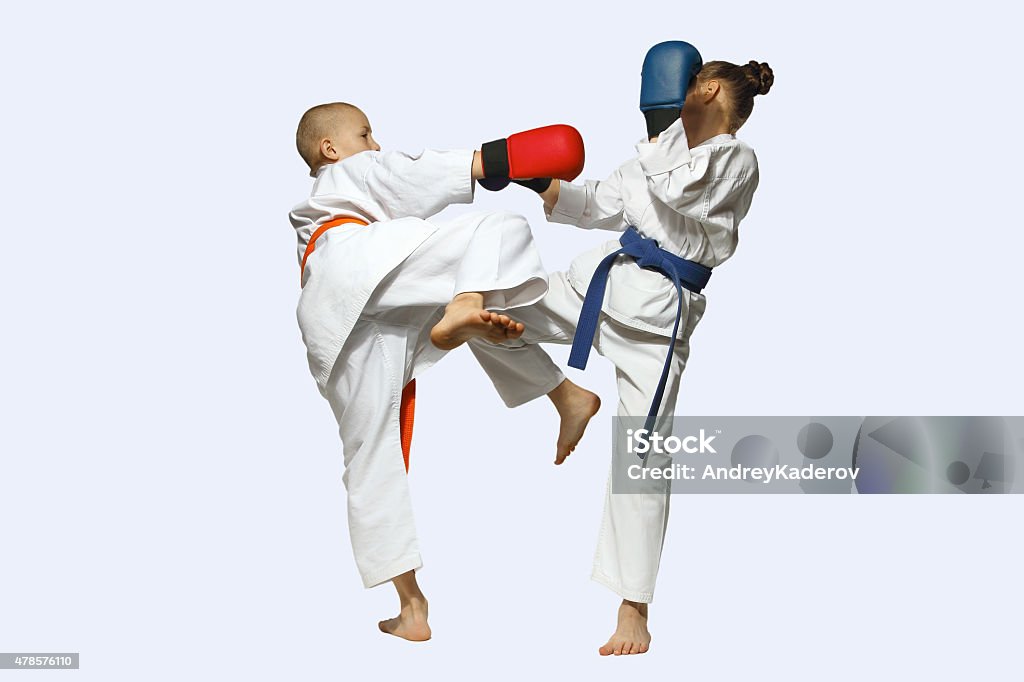 Girl and boy in karategi exchanged blows legs 2015 Stock Photo