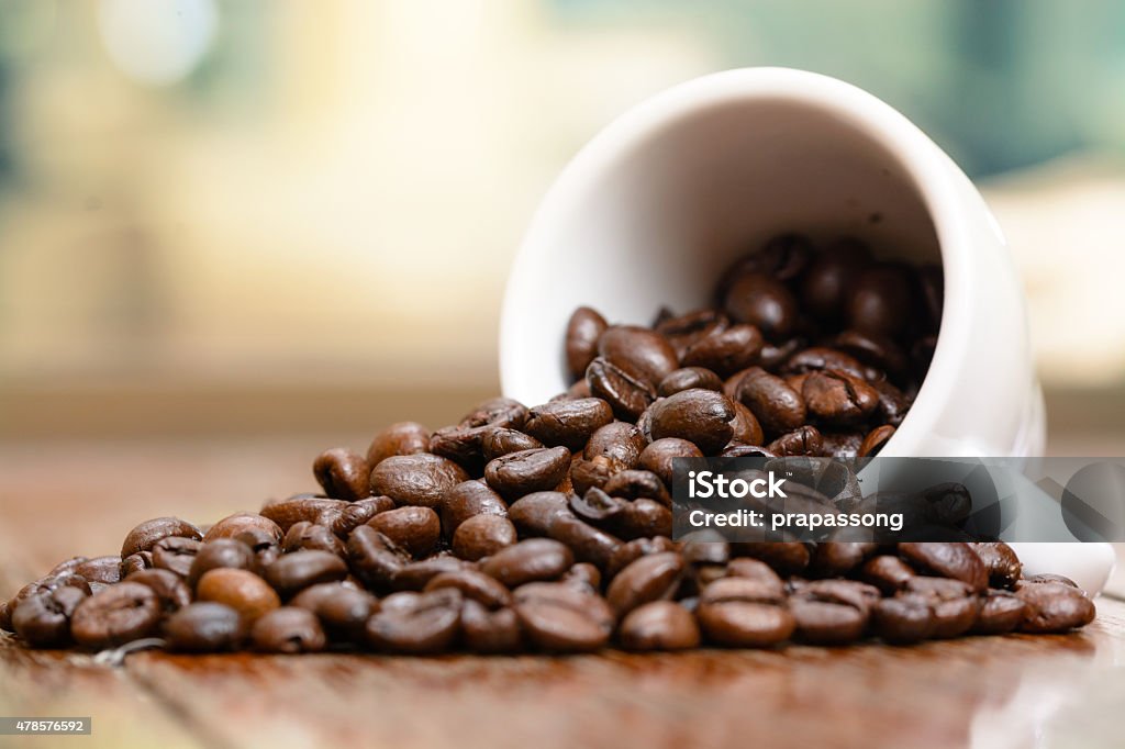 Coffee beans cup on wooden table by window 2015 Stock Photo