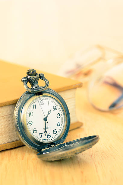 istock Vintage old pocket watch and book 478576672