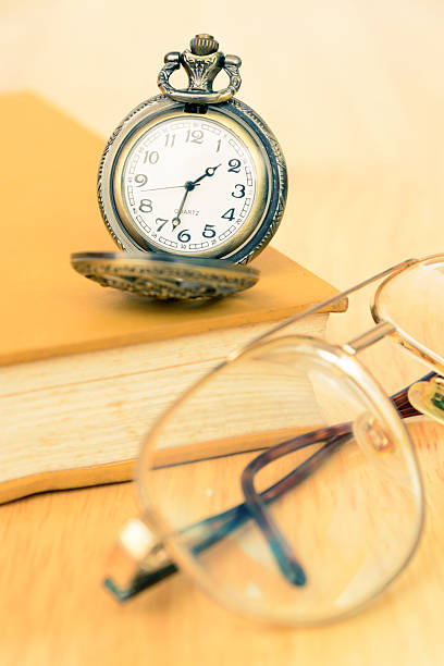 istock Vintage old pocket watch and book 478576880