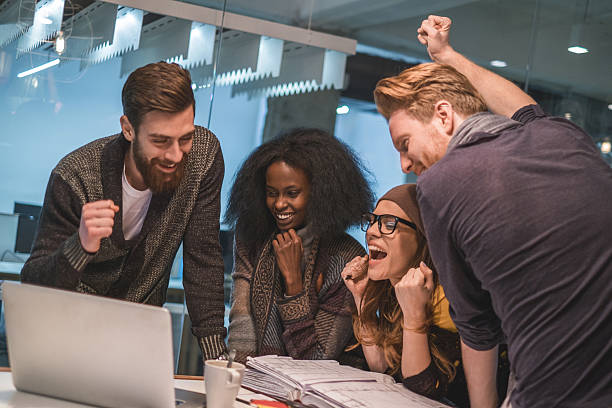 istock Cheerful start up team celebrating their success in the office. 478577034